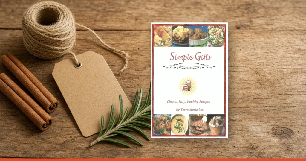Simple Gifts cookbook by Torre Marie Lee on a rustic wooden table with twine, a gift tag, cinnamon sticks and rosemary